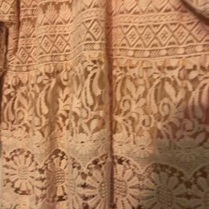 Light coral, lace made with heavy thread.